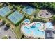 Areal view of the tennis courts with meticulously maintained landscaping, swimming pool, and playground adjacent at 525 Appalachian Pl, Canton, GA 30114