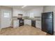 The kitchen has white cabinets, neutral countertops, and standard appliances at 6108 Mount Zion Blvd, Ellenwood, GA 30294