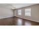 Living room featuring hardwood floors, neutral paint, and two bright windows at 6108 Mount Zion Blvd, Ellenwood, GA 30294