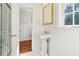Elegant bathroom with a pedestal sink, white wainscoting, and a glass-enclosed shower at 890 W Wesley Nw Rd, Atlanta, GA 30327