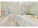 Elegant bathroom with a soaking tub, large vanity with dual sinks, and neutral tile flooring at 890 W Wesley Nw Rd, Atlanta, GA 30327