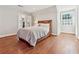 Cozy bedroom with hardwood floors, a sleigh bed, and a window with plantation shutters at 890 W Wesley Nw Rd, Atlanta, GA 30327