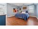 Comfortable bedroom with hardwood floors, a queen-sized bed, and two windows at 890 W Wesley Nw Rd, Atlanta, GA 30327