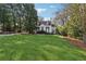 Wide shot of a classic home featuring a spacious front yard and mature trees at 890 W Wesley Nw Rd, Atlanta, GA 30327