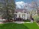 Charming white home with lush front lawn, mature trees, and a welcoming staircase entrance at 890 W Wesley Nw Rd, Atlanta, GA 30327