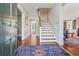 Inviting foyer with hardwood floors, a staircase, and views into other rooms at 890 W Wesley Nw Rd, Atlanta, GA 30327