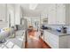 Bright eat-in kitchen featuring stainless steel appliances, white cabinetry, and blue patterned wallpaper at 890 W Wesley Nw Rd, Atlanta, GA 30327