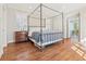 Spacious main bedroom with a four-poster bed, hardwood floors, and plenty of natural light at 890 W Wesley Nw Rd, Atlanta, GA 30327