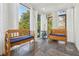 Bright sunroom featuring slate flooring, exposed brick, bench seating, and large windows at 890 W Wesley Nw Rd, Atlanta, GA 30327