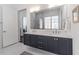 Modern bathroom with double sink vanity, a large mirror, and walk-in shower at 1200 Ponce De Leon Ne Ave # A-19, Atlanta, GA 30306