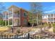 Beautiful brick townhome with white trim, featuring double balconies and well-maintained landscaping at 1200 Ponce De Leon Ne Ave # A-19, Atlanta, GA 30306