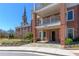 Brick building with multiple floors, stone pavers, green space, and manicured landscaping at 1200 Ponce De Leon Ne Ave # A-19, Atlanta, GA 30306