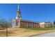 Stunning brick building with a steeple, complemented by manicured grounds and mature trees at 1200 Ponce De Leon Ne Ave # A-19, Atlanta, GA 30306