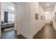 Bright hallway featuring dark hardwood floors, fresh paint, and access to bedroom with large window at 1200 Ponce De Leon Ne Ave # A-19, Atlanta, GA 30306