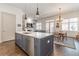 Bright kitchen with a gray island, stainless steel appliances, and an open view to the living room at 1200 Ponce De Leon Ne Ave # A-19, Atlanta, GA 30306