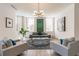 Bright living room with ample seating, modern light fixture, and large windows at 1200 Ponce De Leon Ne Ave # A-19, Atlanta, GA 30306