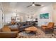 Open-concept living room with stylish furniture, ceiling fan, and view into kitchen and dining area at 1200 Ponce De Leon Ne Ave # A-19, Atlanta, GA 30306