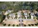 Aerial view showcasing the property surrounded by lush landscaping, community lake, and mature trees at 3185 Casteel Ne Rd, Marietta, GA 30062