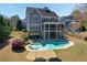 Aerial view of the home showcasing the backyard pool, landscaping, and surrounding neighborhood at 3185 Casteel Ne Rd, Marietta, GA 30062