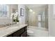 Well-lit bathroom featuring a granite countertop vanity, and shower with a glass door and tiled surround at 3185 Casteel Ne Rd, Marietta, GA 30062