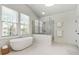 Bright bathroom featuring a soaking tub, walk-in shower, and tile flooring at 3185 Casteel Ne Rd, Marietta, GA 30062