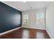 Bedroom featuring hardwood floors, accent wall, and two windows at 3185 Casteel Ne Rd, Marietta, GA 30062