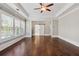 Large bedroom with hardwood flooring, trey ceilings, and a sliding barn door at 3185 Casteel Ne Rd, Marietta, GA 30062