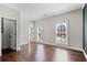 Bright bedroom with hardwood floors, two windows, and a walk-in closet at 3185 Casteel Ne Rd, Marietta, GA 30062