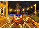 Cozy outdoor fire pit area with Adirondack chairs, string lights, and a view of the pool at 3185 Casteel Ne Rd, Marietta, GA 30062