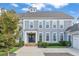 Charming two-story home with a welcoming front porch, well-manicured landscaping, and gray shingle siding at 3185 Casteel Ne Rd, Marietta, GA 30062