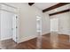 Bright hallway features hardwood floors, white trim, beams, and multiple doorways at 3185 Casteel Ne Rd, Marietta, GA 30062