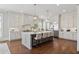 Bright kitchen boasts an island with seating, pendant lighting, and stainless steel appliances at 3185 Casteel Ne Rd, Marietta, GA 30062