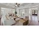 Open concept living room flowing into the kitchen, featuring hardwood floors, a ceiling fan, and ample lighting at 3185 Casteel Ne Rd, Marietta, GA 30062