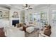 Bright living room with fireplace, built-in shelving, ceiling fan, and sliding glass doors to the porch at 3185 Casteel Ne Rd, Marietta, GA 30062
