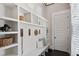 Mudroom features a custom storage, bench seating, and black tiled floor near the entry door at 3185 Casteel Ne Rd, Marietta, GA 30062