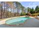 Inviting backyard pool with stone surround, complemented by a spa, lakeside view, and manicured landscaping at 3185 Casteel Ne Rd, Marietta, GA 30062