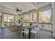 Relaxing screened-in porch with a ceiling fan, seating, and outdoor dining area, ideal for enjoying nature at 3185 Casteel Ne Rd, Marietta, GA 30062