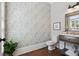 Charming powder room with stylish wallpaper, elegant vanity, and modern fixtures, creating a sophisticated space at 3185 Casteel Ne Rd, Marietta, GA 30062