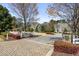 Charming street view showcasing the home's entrance with manicured landscaping and brick driveway at 3185 Casteel Ne Rd, Marietta, GA 30062