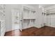 Walk-in closet with custom shelving and wooden floors at 3185 Casteel Ne Rd, Marietta, GA 30062