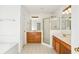 Bright bathroom with double vanities, a glass shower, and a large soaking tub at 3242 Monarch Pine Nw Dr, Peachtree Corners, GA 30071