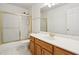 A well-lit bathroom with a shower and tub combination featuring a sliding glass door and a single sink at 3242 Monarch Pine Nw Dr, Peachtree Corners, GA 30071