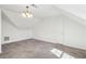 A carpeted bonus room featuring vaulted ceilings and a modern light fixture at 3242 Monarch Pine Nw Dr, Peachtree Corners, GA 30071