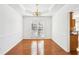 Bright dining room features hardwood floors, tray ceiling, and wainscoting at 3242 Monarch Pine Nw Dr, Peachtree Corners, GA 30071