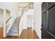 Bright foyer with hardwood floors, carpeted staircase, and natural light streaming in from the entrance at 3242 Monarch Pine Nw Dr, Peachtree Corners, GA 30071