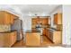 Spacious kitchen with wood cabinets, granite countertops, stainless steel appliances, and a center island at 3242 Monarch Pine Nw Dr, Peachtree Corners, GA 30071