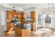 Charming kitchen featuring wood cabinets, a center island with granite counters and stainless-steel appliances at 3242 Monarch Pine Nw Dr, Peachtree Corners, GA 30071