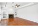 Bright living room with hardwood floors, a marble fireplace, and large windows at 3242 Monarch Pine Nw Dr, Peachtree Corners, GA 30071