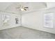 A spacious main bedroom features an elegant tray ceiling and two windows at 3242 Monarch Pine Nw Dr, Peachtree Corners, GA 30071