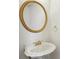 A traditional powder room with white pedestal sink, ornate faucet, and round mirror at 3242 Monarch Pine Nw Dr, Peachtree Corners, GA 30071